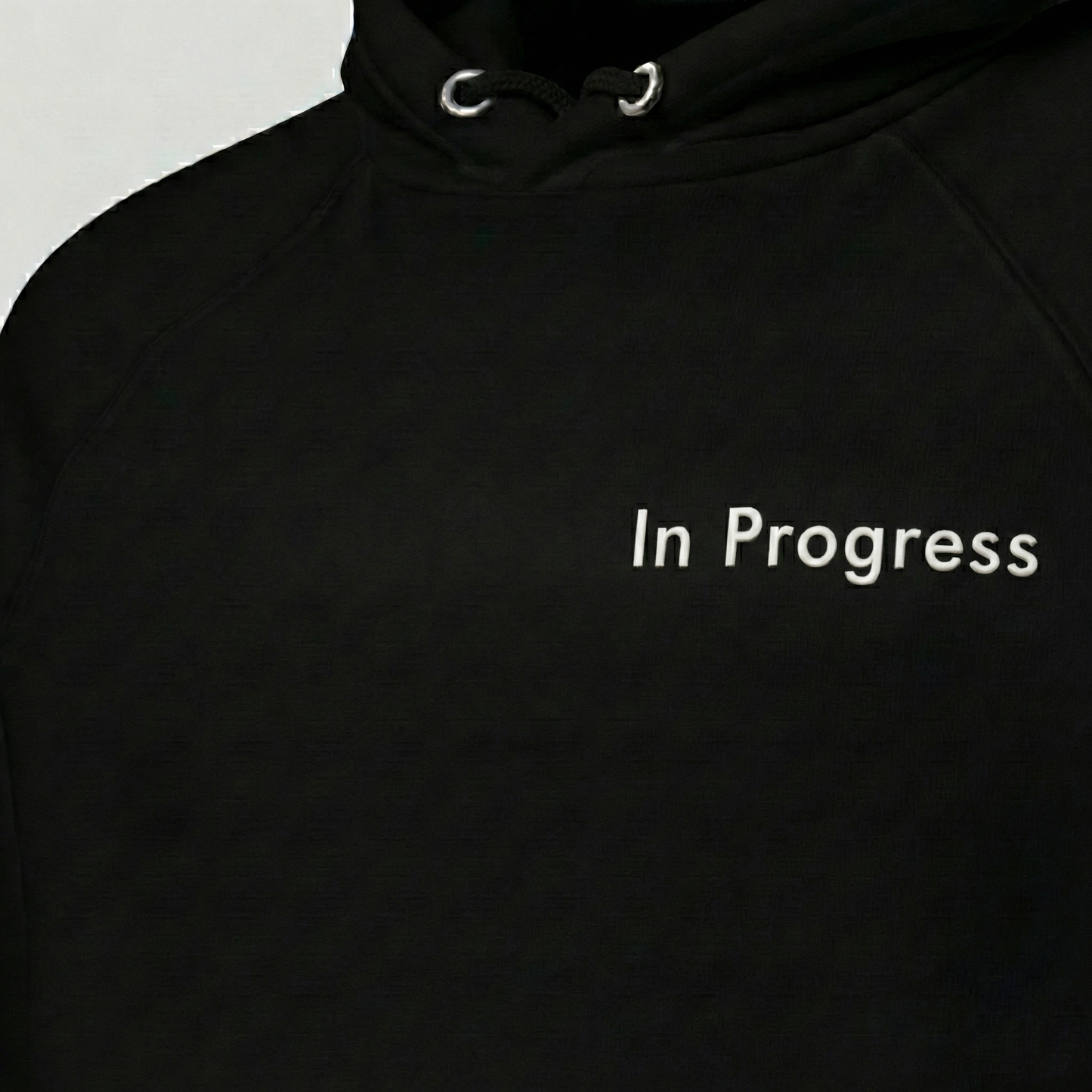 Black In Progress hoodie with minimalist text print